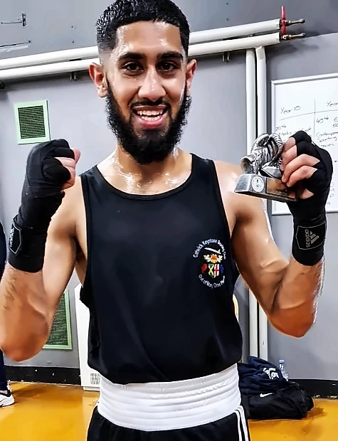 A Gatwick Keystone boxer celebrating with his trophy
