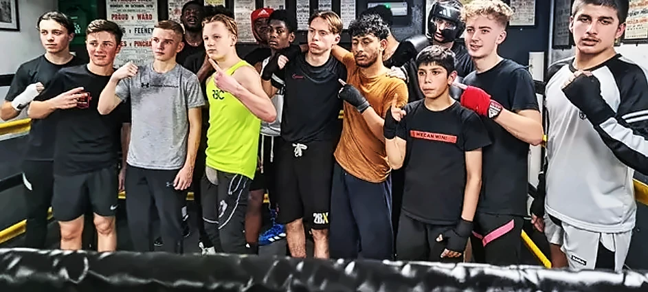 Junior boxers lined up in the gym